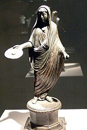 A Roman priest, his head ritually covered with a fold of his toga, extends a patera in a gesture of libation (2nd-3rd century) RMW - Opfernder Togatus.jpg