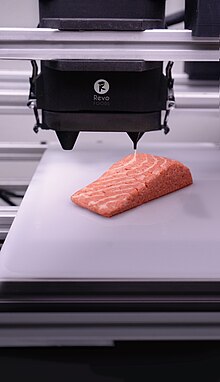 A plant-based salmon filet alternative by Austrian company Revo Foods, which was produced with 3D food prinitng in a multi-print-head setup, combining mycoprotein and plant-based fat to recreate the structure of conventional salmon filets. Revo Foods-THE-FILET-06-printer.jpg