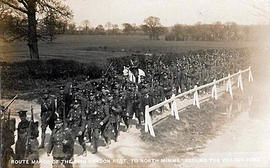 Route march of the 24th London Regiment to North Mimms, passing the village pond (ca 1910). Route March 24 London Regt.jpg