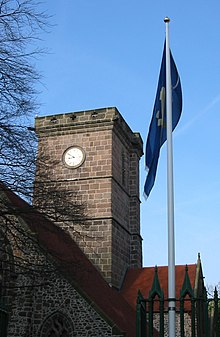 The tower Saint Helier Parish Church with flag Jersey.jpg