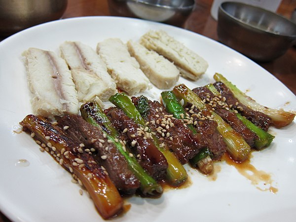 Sanjeok (skewered beef and scallions) and dombaegi (salted shark meat)