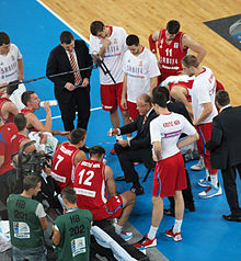 The Serbia men's national basketball team huddles to discuss strategy during a time-out at EuroBasket 2013 Serbian team timeout Eurobasket 2013.jpg