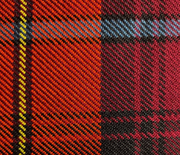 Close-up view of traditional tartan cloth, showing pattern of diagonal "ribs" of colour; this is a five-colour tartan, in scarlet red, black, yellow, 