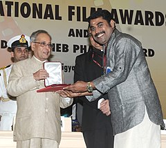 The President, Shri Pranab Mukherjee presenting the Rajat Kamal Award for Best Actor (Shared) Perariyathavar (Malayalam) to Shri Suraj Venjaramoodu, at the 61st National Film Awards function, in New Delhi on May 03, 2014.jpg