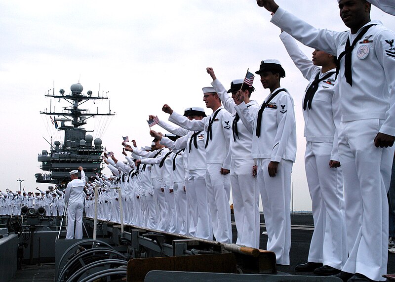 File:US Navy 030529-N-7130B-501 Sailors man the rails as USS Theodore Roosevelt (CVN 71) is given a hero's welcome by friends and family members on the pier.jpg