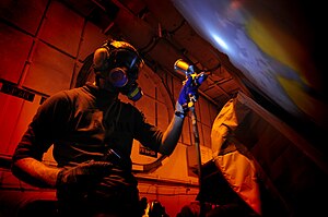 US Navy 120125-N-MD252-759 Aviation Structural Mechanic Airman David Southworth, assigned to Electronic Attack Squadron (VAQ) 134, paints an EA-6B .jpg