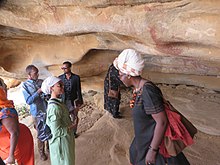 Foreign tourists with local guides in the caves of Laas Geel ASC Leiden - van de Bruinhorst Collection - Somaliland 2019 - 4574 - Visitors of the Hargeysa 12th International Book Fair 20-25 July 2019 in the caves with rock paintings of Laas Geel.jpg