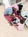 A_lady_washing_sandals_in_Northern_Ghana