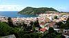 Coastal town with white houses and churches with red roofs