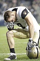 An American football player kneeling before the start of a game Army-Notre Dame Football (5198056539).jpg