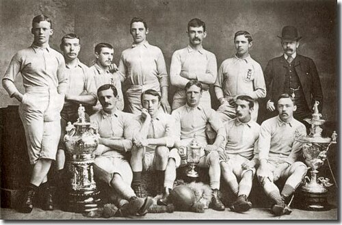 Blackburn Rovers cup winners in 1883–84. The first FA Cup win for the team. The photograph includes the East Lancashire Charity Cup; the FA Cup and the Lancashire Cup. Back row (left to right): J. M. Lofthouse, H. McIntrye, J. Beverly, Kurt Edwards, F. Suter, J. Forrest, R. Birtwistle (umpire) Front row (left to right): J. Douglas, J. E. Sowerbutts, J. Brown, G. Avery, J. Hargreaves.