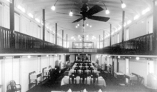 Interior of gallery deck overlooking salon deck on Bonnington, sister ship of Nasookin. Bonnington (sternwheeler) dining salon ca 1912.PNG