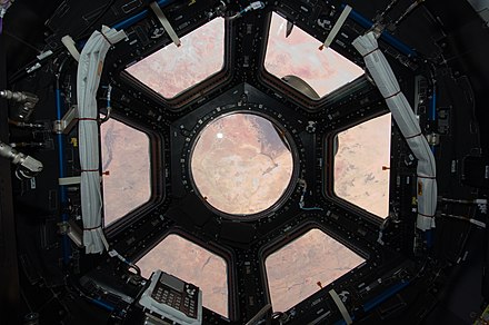 The first photograph taken in the Cupola, one of two ISS modules installed during STS-130