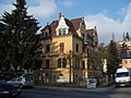 Tenement house with fencing in a corner and open development