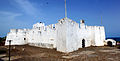 Exterior photograph of Fort Metal Cross, Dixcove, Western Region, Ghana. It is composed of two images stitched together taken from just outside