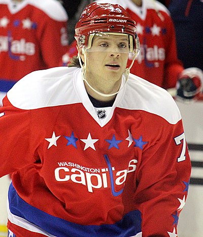 The play of defenseman John Carlson, shown here wearing the Capitals red throwback uniform, has been a key part of the Capitals' success during the Ovechkin era.
