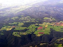 Aerial view of the Kinglake area looking north, nine months after bushfires (burnt area top third of image) Kinglake aerial.jpg