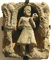 A Yuezhi/ Kushan man in traditional costume with tunic and boots, 2nd century CE, Gandhara. KushanMan.JPG