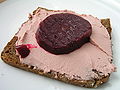 open sandwich of Danish rye bread with liver paté and pickled beetroot