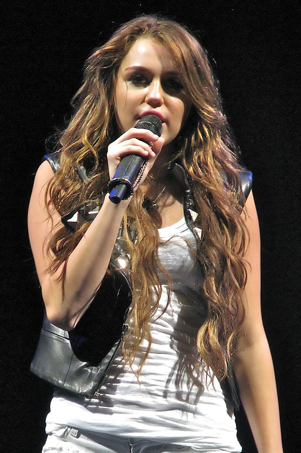Cyrus performing the album's lead single "The Climb" at the Wonder World Tour. The song talks about remaining optimistic and became a big adult contem