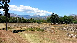 The unused fields and a far mountain range