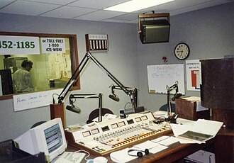 Radio station WBNI-FM with four SM7s on boom arms Radio studio of WBNI, showing console.jpg