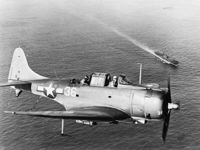 File:SBD-5 of VB-10 over USS Enterprise (CV-6) 1944.jpg