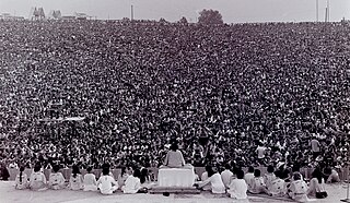 August 15-17, 1969: Hundreds of thousands attend the Woodstock festival Swami opening.jpg