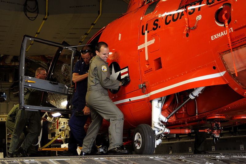 File:U.S. Air Force Tech. Sgt. Michael Smith, right, a loadmaster with the 300th Airlift Squadron, assists in unloading an MH-65C Dolphin helicopter, assigned to the U.S. Coast Guard, from a C-17 Globemaster III 100704-F-PM120-101.jpg