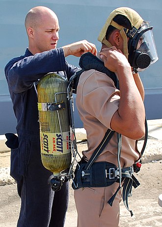 A Royal Thai Navy sailor dons a self-contained breathing apparatus. US Navy 090711-N-5207L-102 Damage Controlman Fireman Jason Hazenfield, assigned to the guided-missile frigate USS Crommelin (FFG 37), helps a Royal Thai Navy sailor don a self-contained breathing apparatus (SCBA) during a damag.jpg