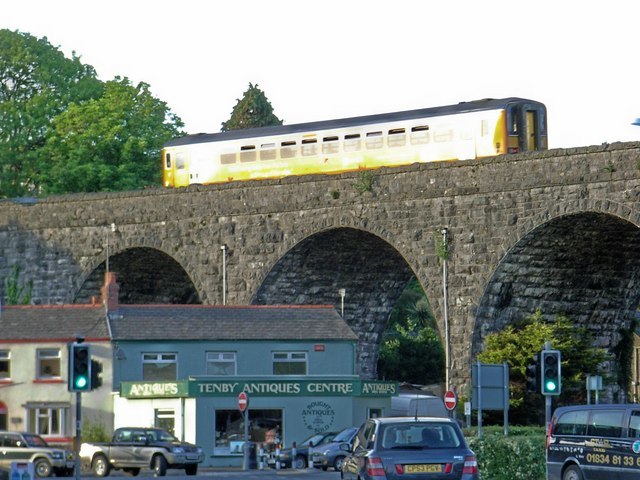 A Class 153 unit in Heart of Wales line livery crosses the viaduct near Tenby railway station c.2007.
