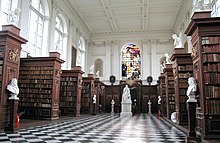 Wren Library interior, showing the limewood carvings by Grinling Gibbons WrenLibraryInterior.jpg