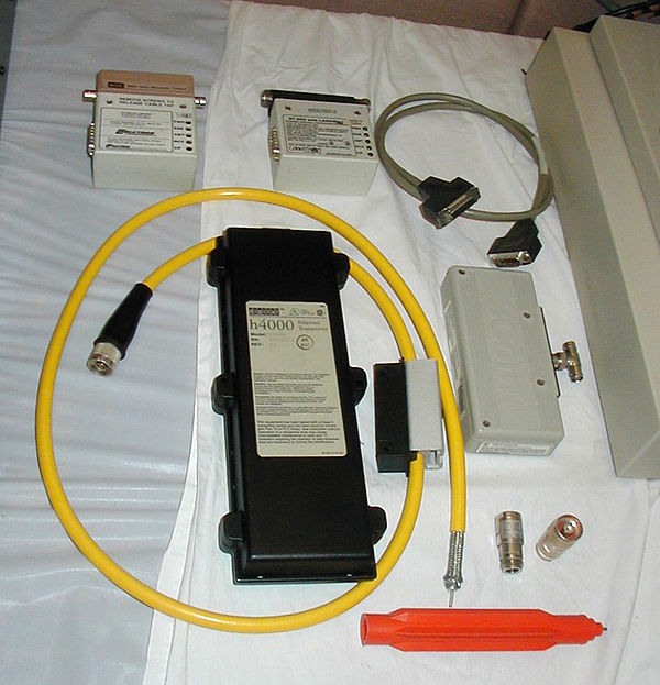 Older Ethernet equipment. Clockwise from top-left: An Ethernet transceiver with an in-line 10BASE2 adapter, a similar model transceiver with a 10BASE5