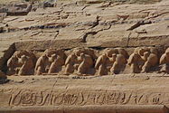 Baboon carvings above the heads of the statues of Ramses at the Great Temple