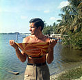 Actor George Hamilton posing with the "Reflect-A-Tan" in Palm Beach (19995867519).jpg