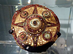 A Saxon copper brooch, decorated with gold and garnets Anglo-Saxon Brooch from Covent Garden in the Museum of London.jpg