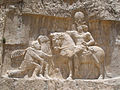 Rock-face relief at نقش رستم of Persian emperor سابور الأول (on horseback) capturing Roman emperors فاليريان (kneeling) and فيليب العربي (standing)