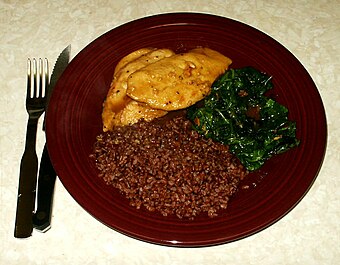 Traditional dish with lemon glazed chicken, sauteed spinach and steamed Bhutanese red rice