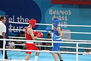 Deutsch: Boxen bei den Olympischen Jugendspielen 2018 Tag 12, 18. Oktober 2018 - Kampf um Bronze im Leichten Weltergewicht Jungen – Hassan Azim (Großbritannien, rot) schlägt Mohammed Boulaouja (Marokko, blau) RSC; Ringrichter ist Wulfren Olivares Peréz (Kolumbien). English: Boxing at the 2018 Summer Youth Olympics on 18 October 2018 – Bronze Medail Match Light Welterweight Boys - Hassan Azim (Great Britain, red) beats Mohammed Boulaouja (Morocco, blue) RSC; Referee is Wulfren Olivares Peréz (Columbia). Español: Boxeo en los Juegos Olímpicos Juveniles de Verano de 2018 en 18 de octubre de 2018 - Medalla de bronce de los hombres ligeros de peso welter: Hassan Azim (Gran Bretaña, rojo) vence a Mohammed Boulaouja (Marruecos, azul) RSC; El árbitro es Wulfren Olivares Peréz (Colombia).