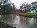 the River Colne flowing through the park. The area to the right is not part of the park, but part of the neighboouring cricket ground.}}