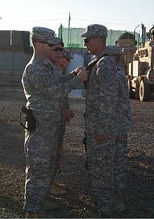 Richardson pins on Combat Action Badges and Purple Heart medals to cavalry troopers at Joint Security Station Ghazaliyah on December 12, 2008. Cavalry Troopers recognized for bravery DVIDS135980.jpg