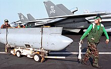 At 17 feet (5.2 m) and weighing 1,850 lb (840 kg), the TARPS is the largest device hung on a Tomcat. Crew moves TARPS pod on USS George Washington.jpg