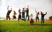 An American family composed of the mother, father, children, and extended family Family jump.jpg