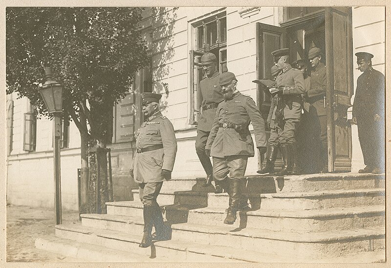 File:German officers exit a building (9365987903).jpg