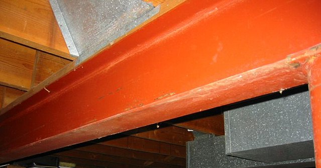 A steel I-beam, in this case used to support timber joists in a house