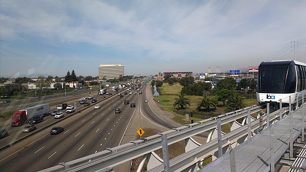 The Coliseum–Oakland International Airport line traverses I-880 in Oakland, with Oakland Coliseum and Arena right of center