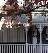 Heritage-listed house showing wrought-iron lacework and corrugated-iron verandah.