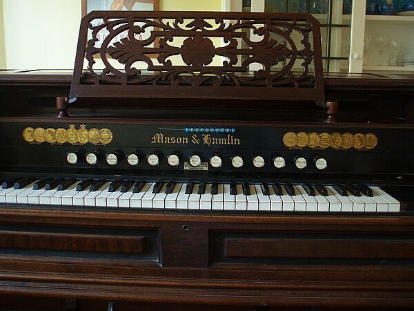 An 1895 Mason & Hamlin Model 512 reed organ. Displayed above the keyboard are the various medals and awards won by the company at international exhibi