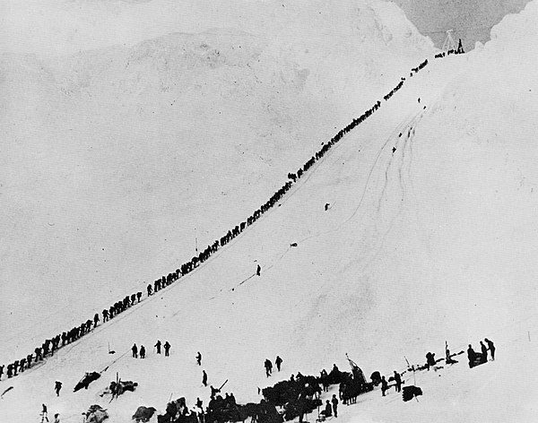 Miners and prospectors climb the Chilkoot Trail during the 1898 Klondike Gold Rush.