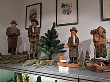 Moss people, both male Moosmannlein ("moss men") and female Moosweiblein ("moss women"), as depicted in traditional German wood art from the Vogtland. Moosmanner und Moosweiblein im Heimatmuseum Falkenstein (5).jpg